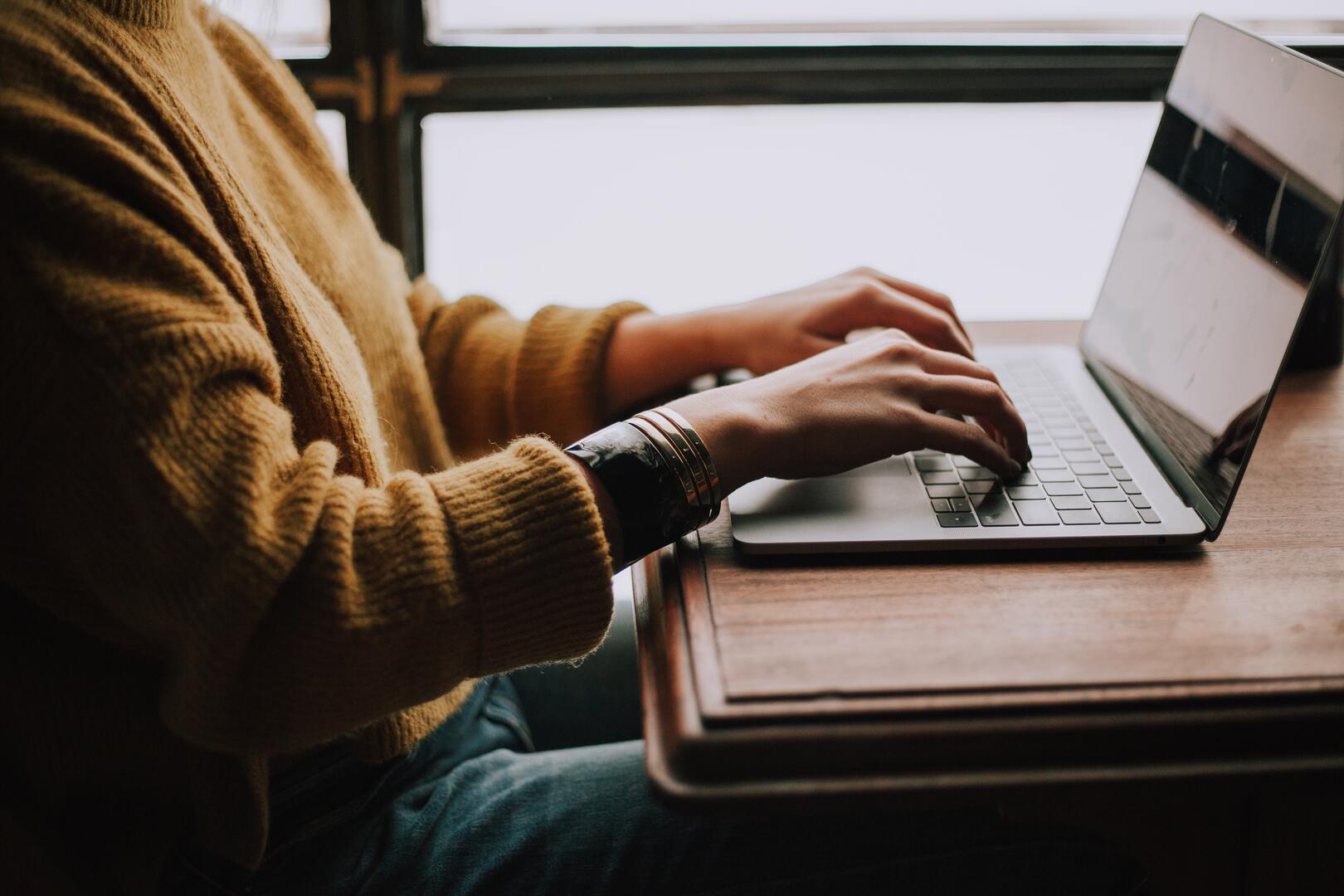 Picture of a person on working on a laptop